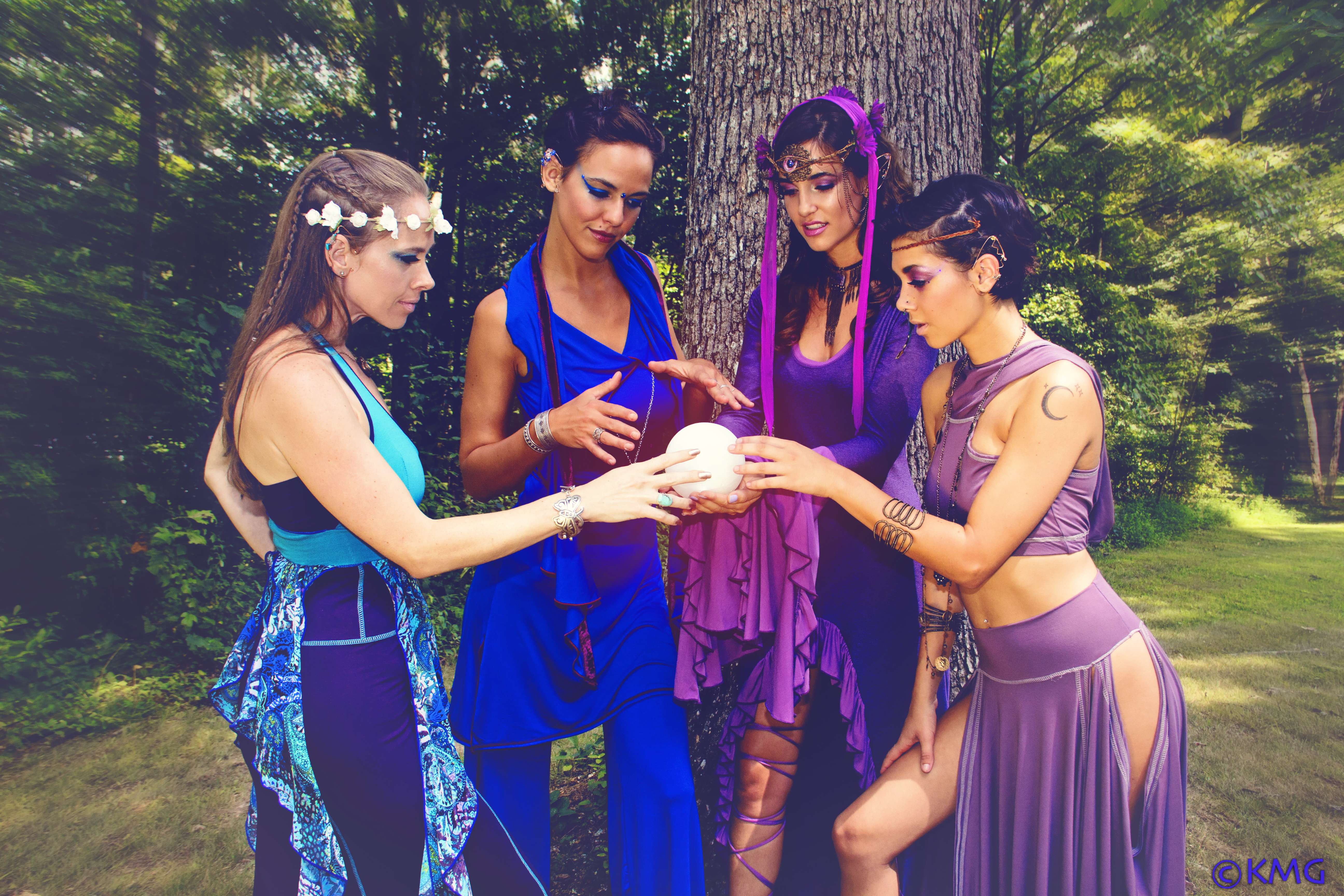 4 woman in elven fairy costumes with crystal ball