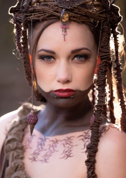 woman with dramatic tribal makeup and forest flower crown by Accentuates Clothing